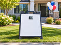 The real tag shown at true size on an open house A-frame sign in a front yard (real product photo on a digital background)