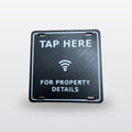 NFC A-Frame Sign Tag: real product photo, black tag with raised white TAP HERE, tap icon and FOR PROPERTY DETAILS, on a studio background