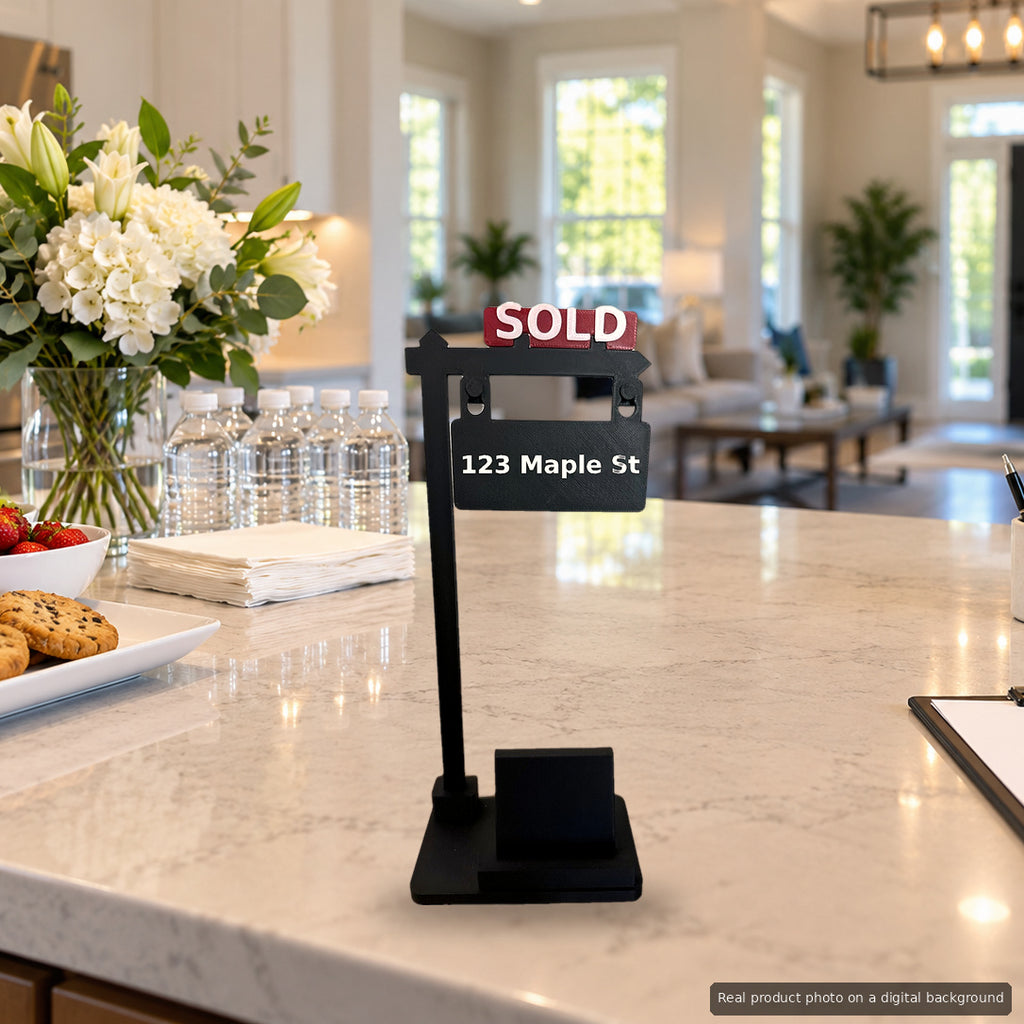 SOLD Sign Phone Stand on an open house kitchen island with snacks and a sign-in sheet (real product photo on a digital background)